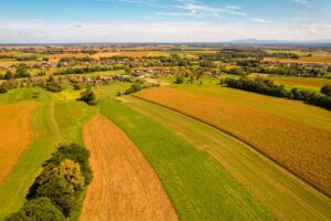 Stunning aerial view of rural landscape in Garešnica, Croatia, showcasing vibrant fields and village scenery.